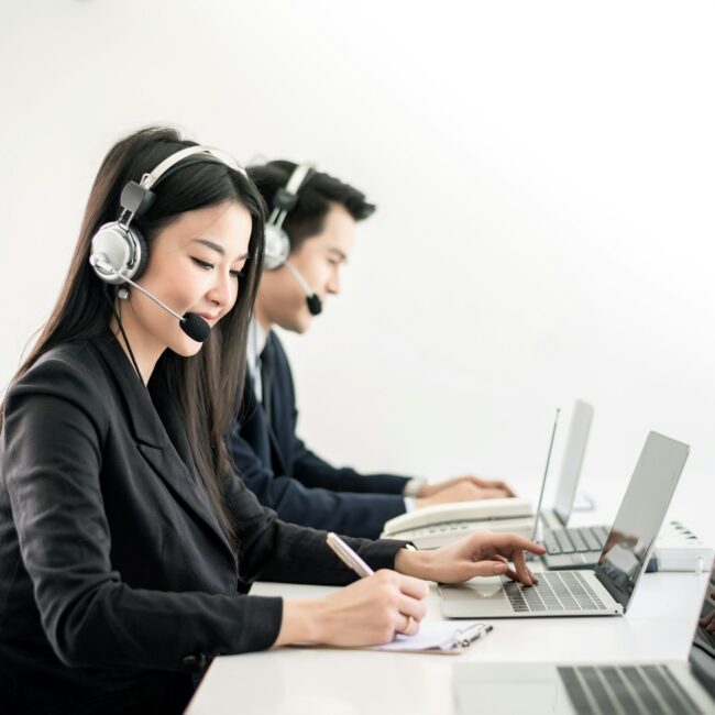 Asian employees work together in the call center in the office.